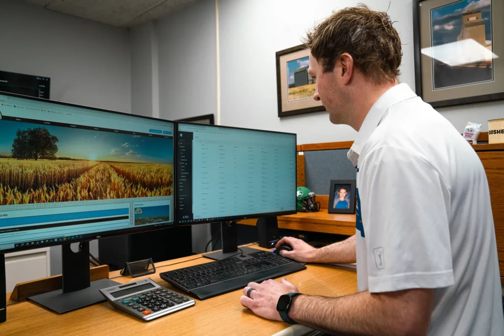 man sitting at computer in an office.