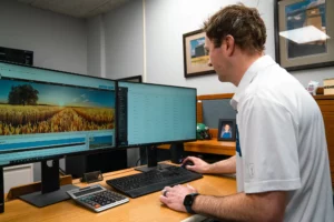 man sitting at computer in an office.